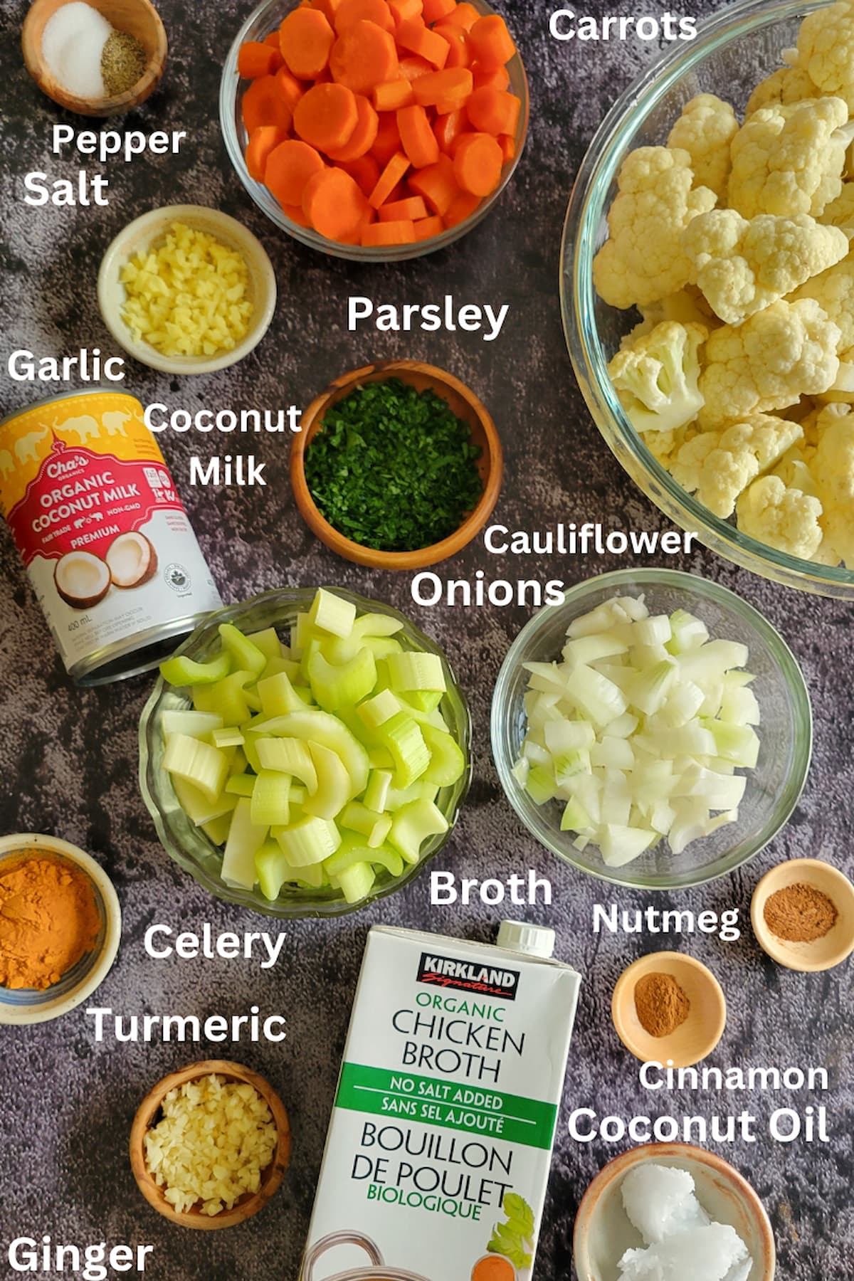 ingredients for soup with cauliflower - cauliflower, carrots, onions, celery, garlic, ginger, salt, pepper, coconut milk, coconut oil, chicken broth, cinnamon, nutmeg, turmeric, parsley