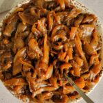 bowl of caramelised onions with a spoon in it