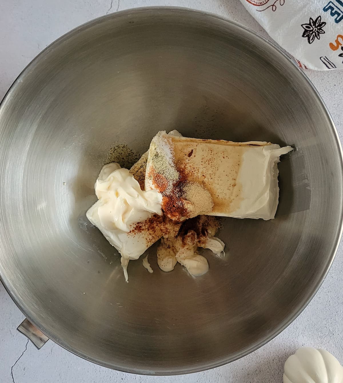 block of cream cheese, mayo and spices unmixed in a bowl