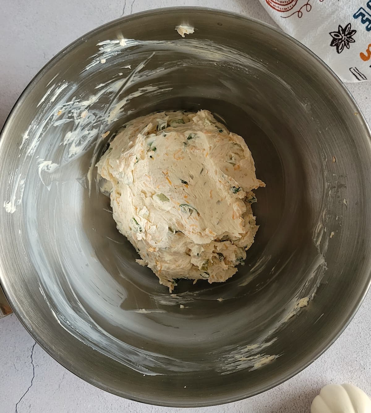 cream cheese and other ingredients mixed into a ball in a bowl