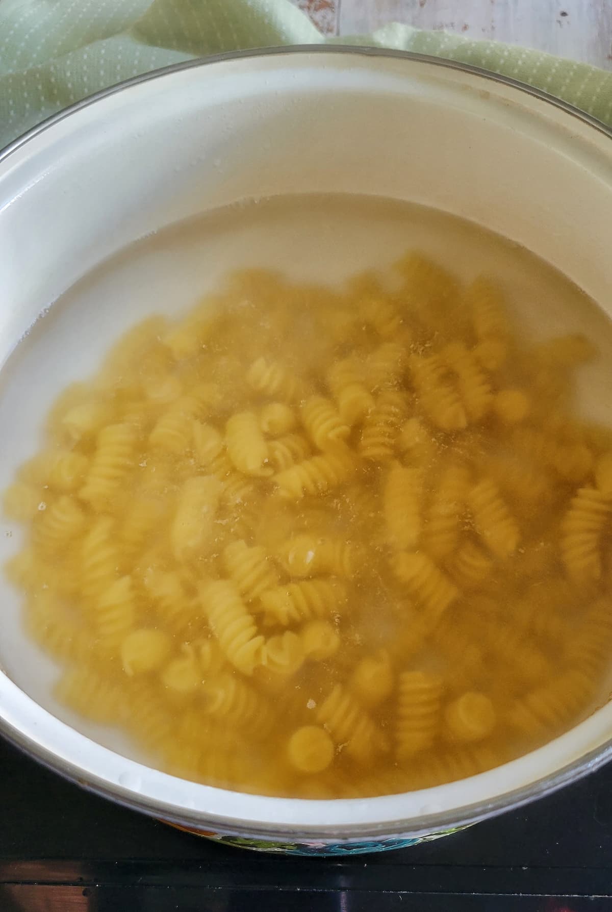 curly pasta in a pot of water
