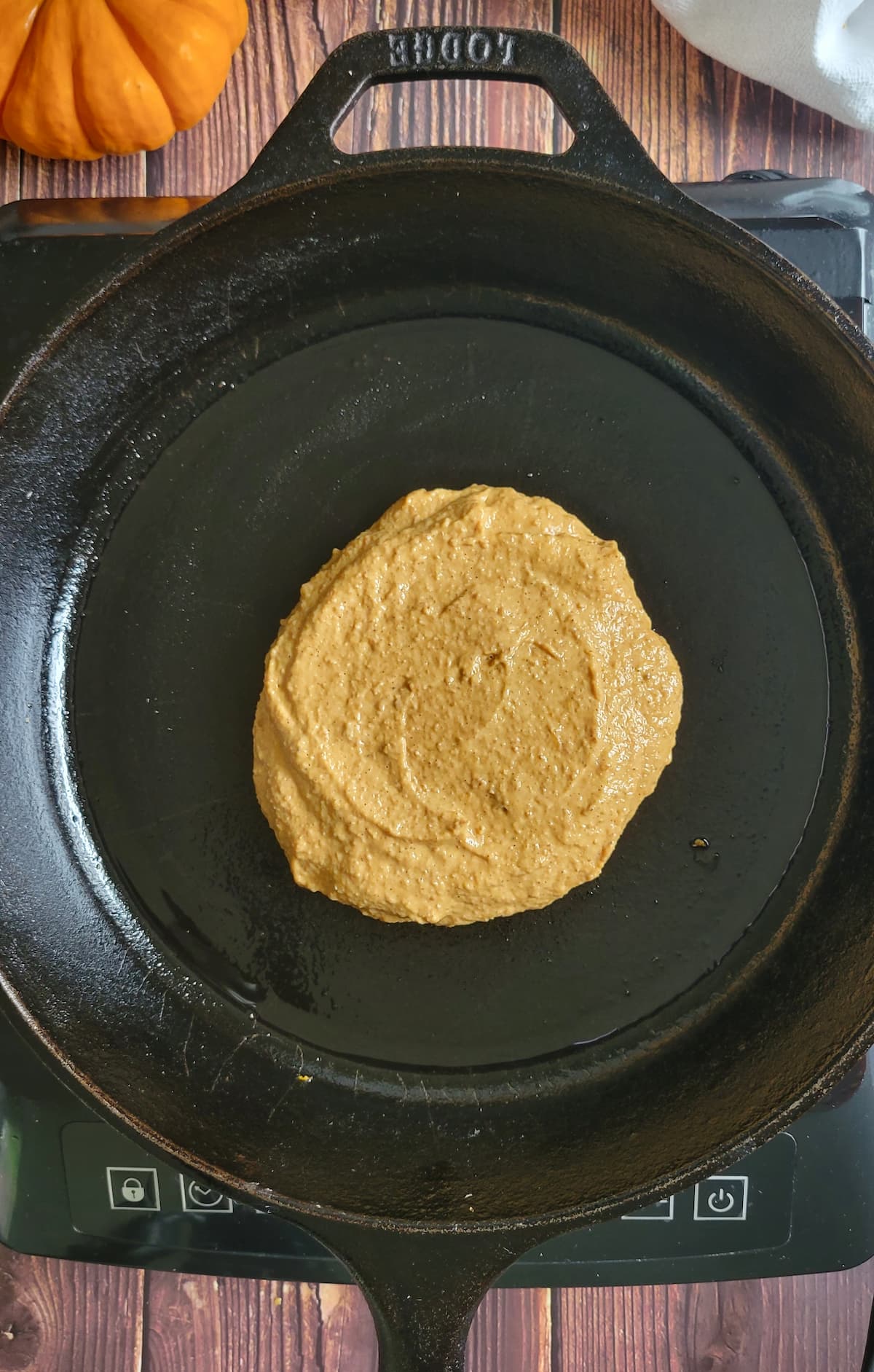 orange pancake cooking in a skillet