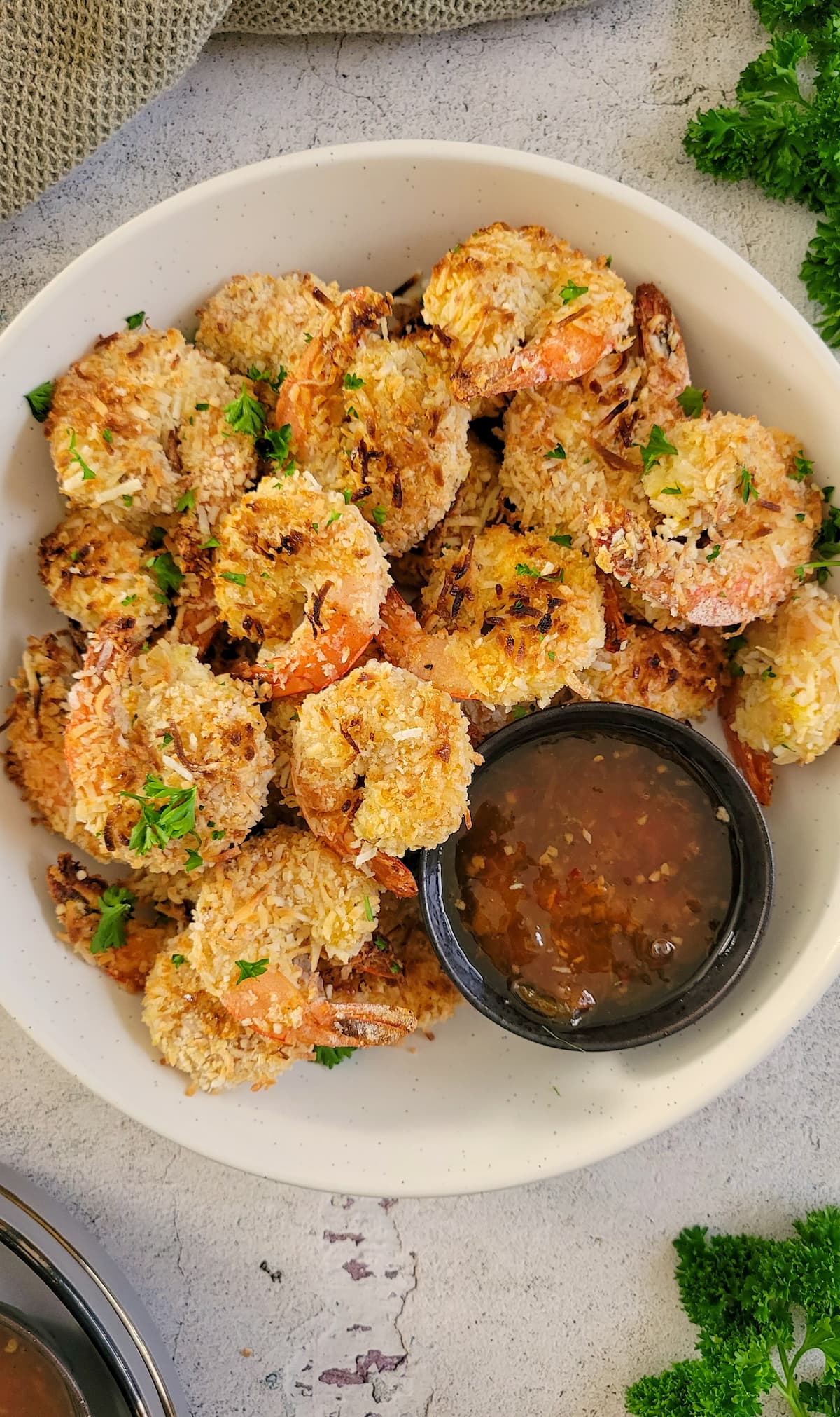 bowl of coconut shrimp with an orange dipping sauce