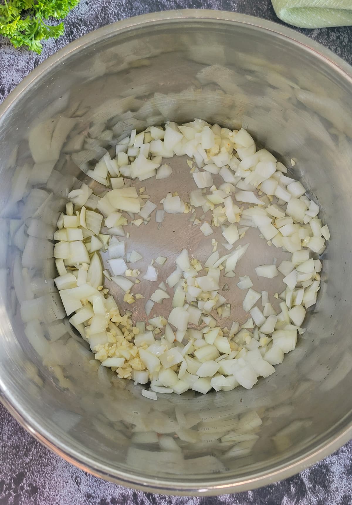 diced onions and garlic in a pot