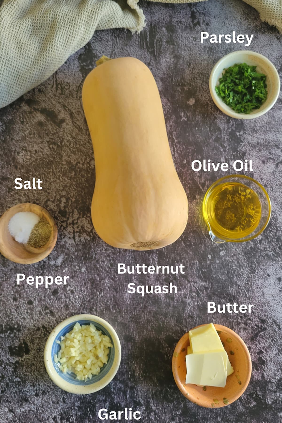 ingredients for roasted butternut squash - butternut squash, garlic, parsley, olive oil, butter, salt, pepper