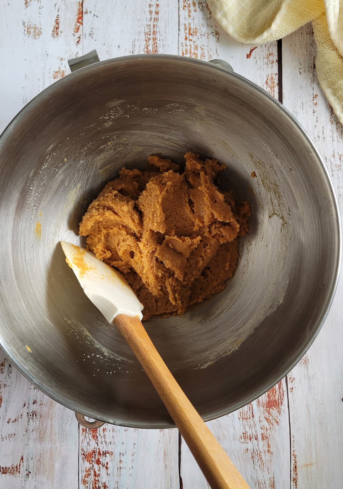 peanut butter dough in a bowl with a rubber spatula
