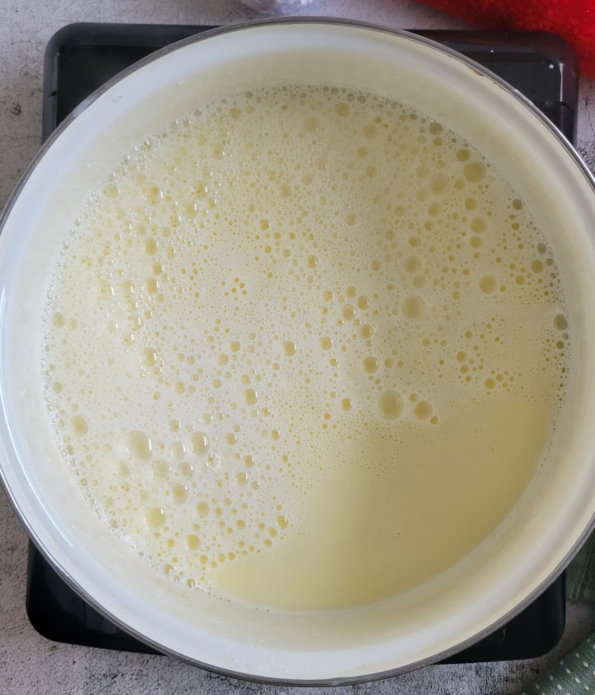 homemade eggnog in a pot on a burner
