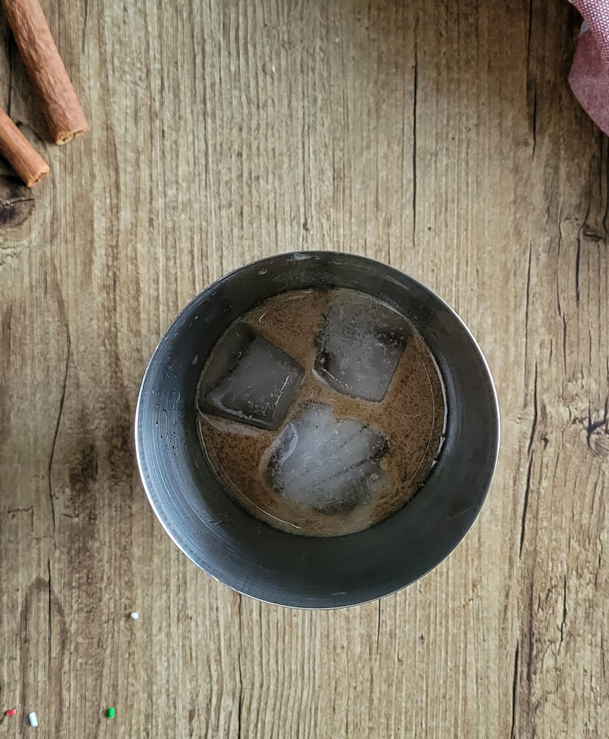 brown liquid with ice in a martini shaker