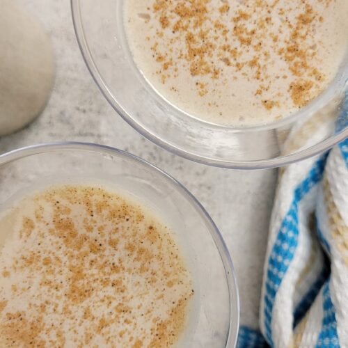 two eggnog martinis garnished with nutmeg