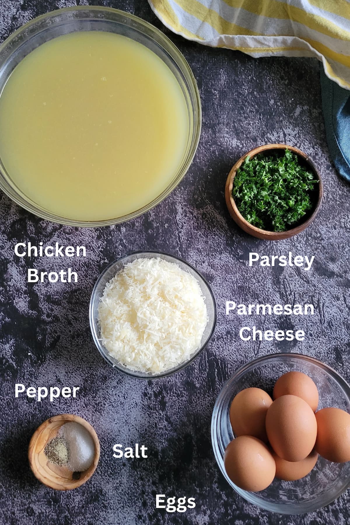 ingredients for soup with eggs - eggs, chicken broth, parsley, salt, pepper, parmesan cheese