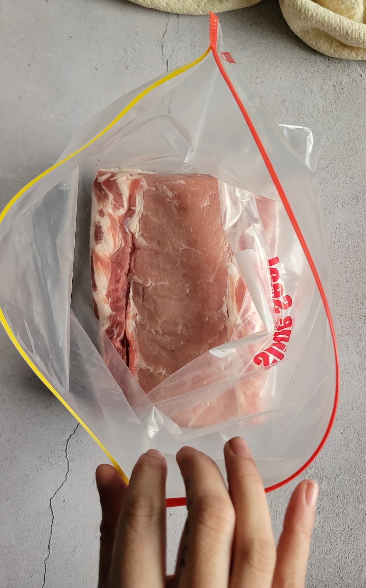 raw whole pork loin in a ziploc bag