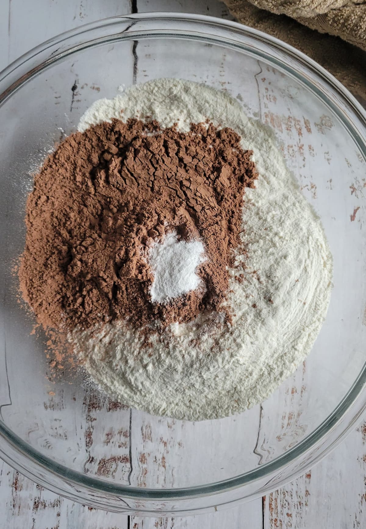 cocoa powder, flour and baking soda unmixed in a bowl