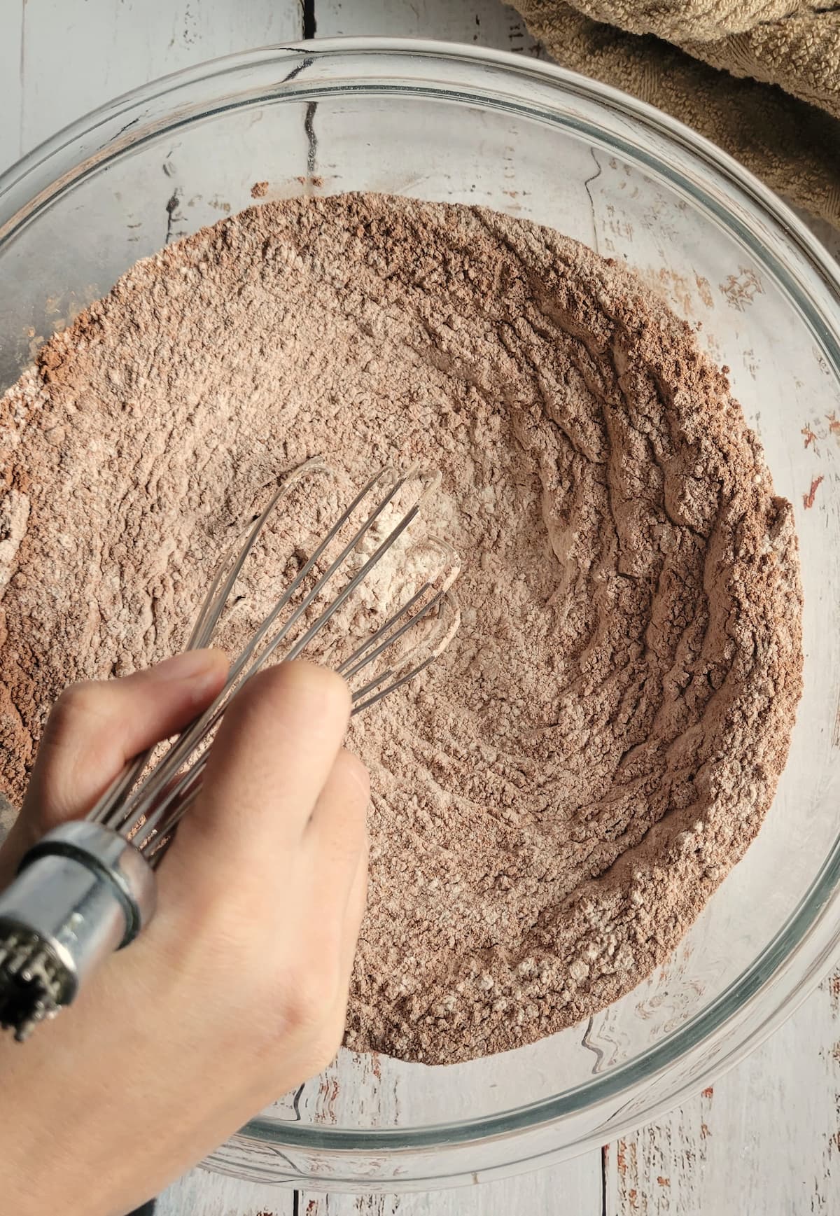 hand whisking cocoa powder and flour together