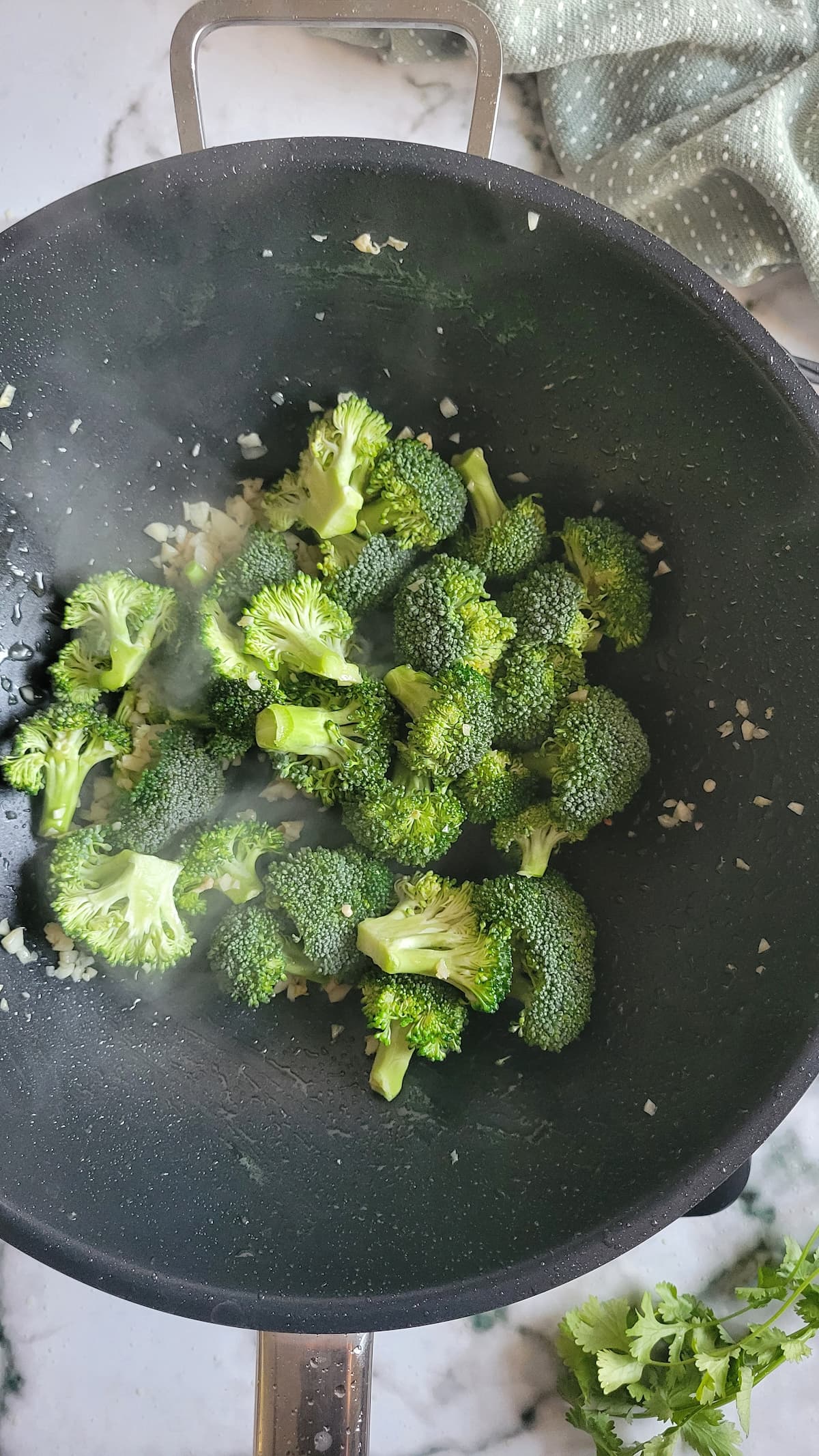 broccoli florets and garlic in a wok
