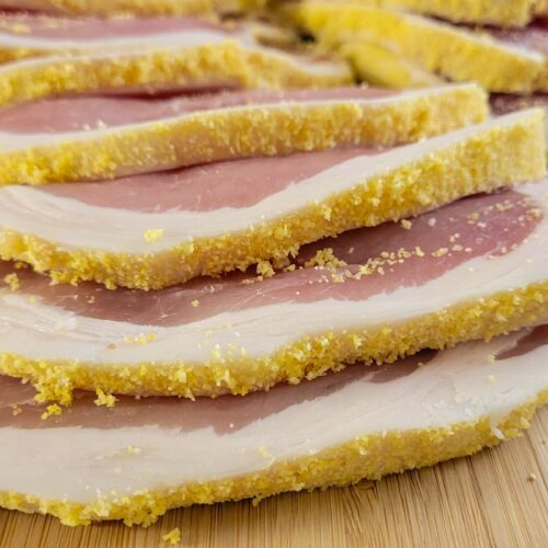 slices of raw peameal bacon on a cutting board