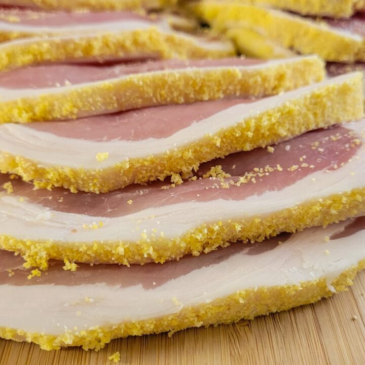 slices of raw peameal bacon on a cutting board