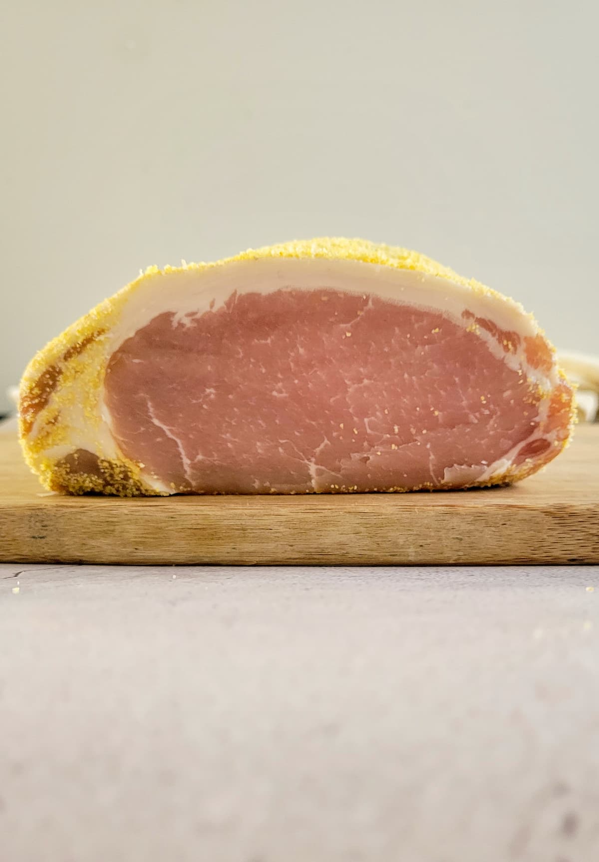 whole slab of peameal bacon on a cutting board