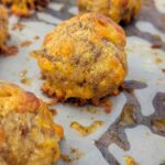 cooked sausage balls on parchment paper