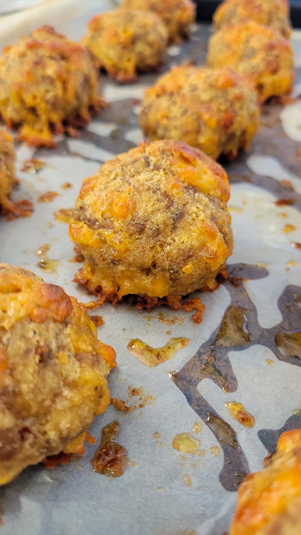 cooked sausage balls on parchment paper