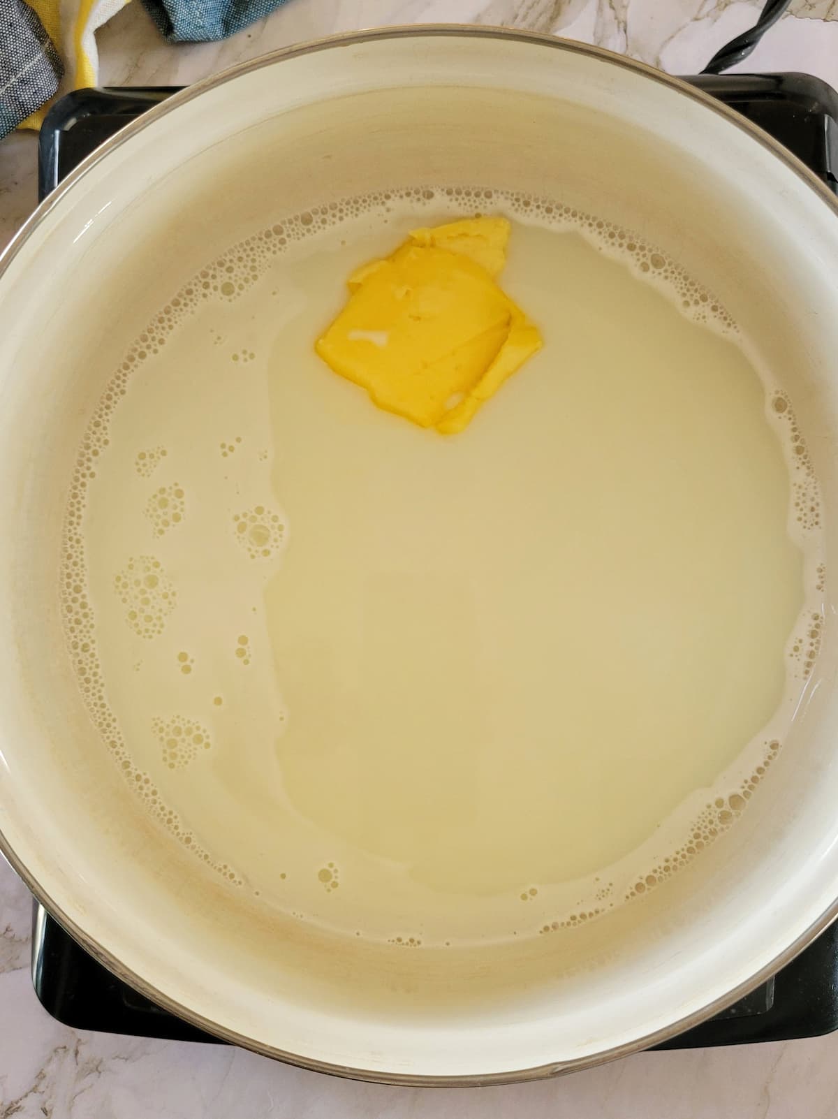 butter in milk in a pot