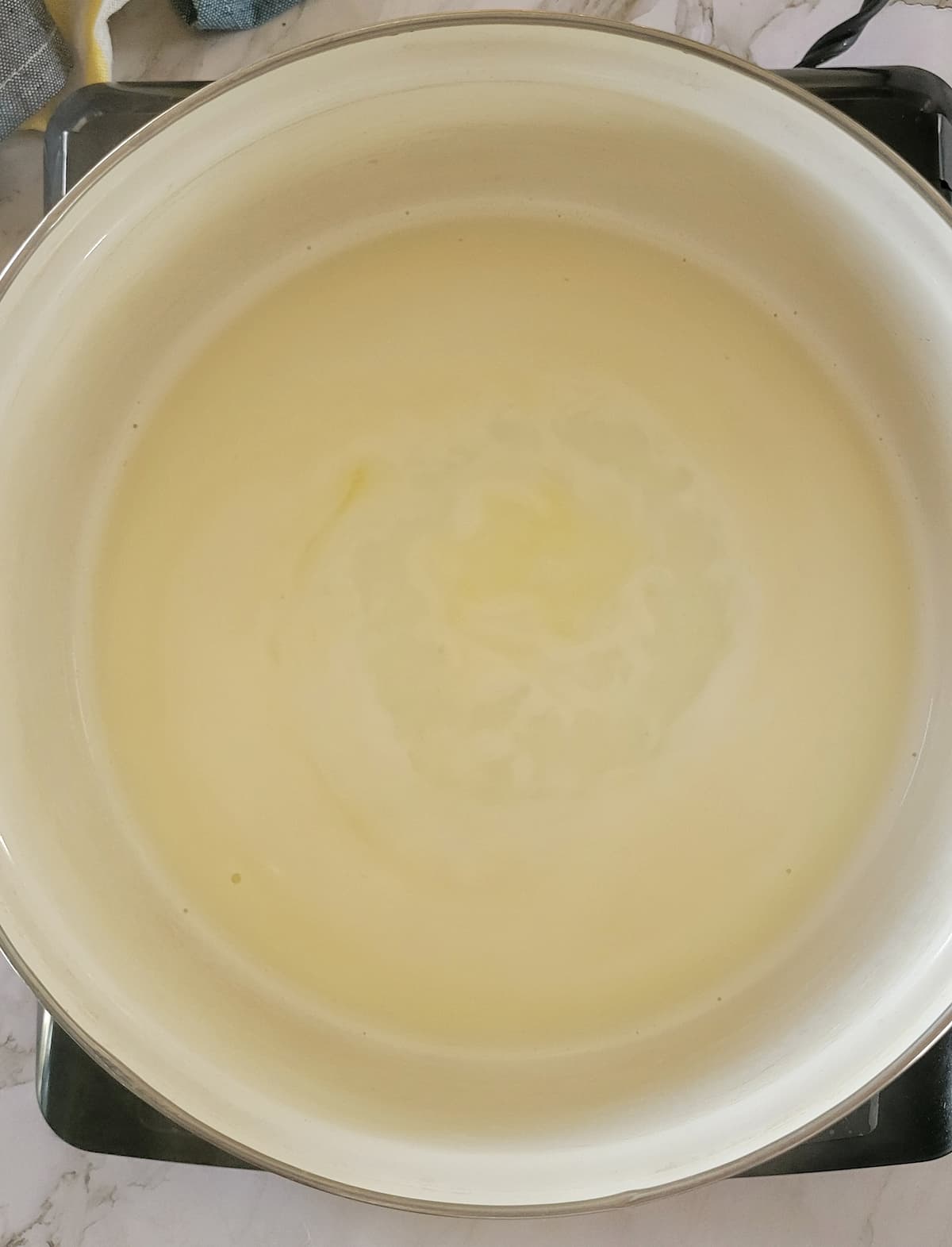 milk simmering in a pot on a burner