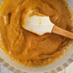 caramel sauce and a rubber spatula in a dish