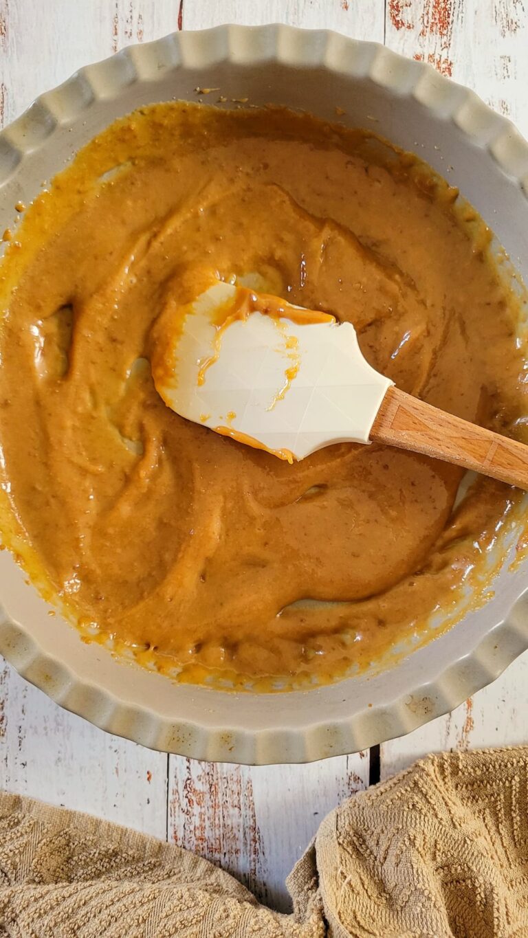 caramel sauce and a rubber spatula in a dish