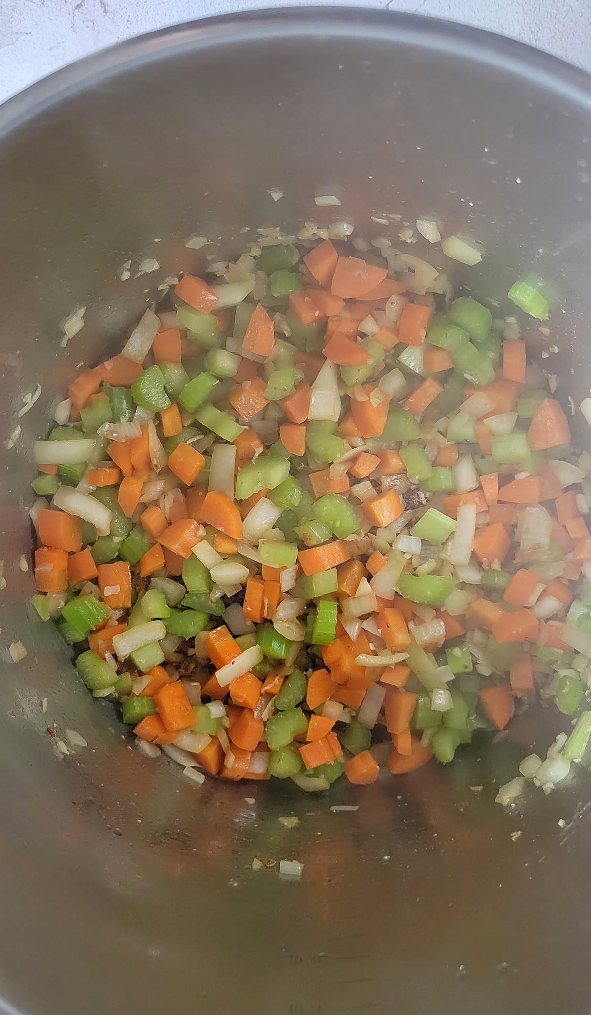 diced celery, carrots, onions and garlic in a pot