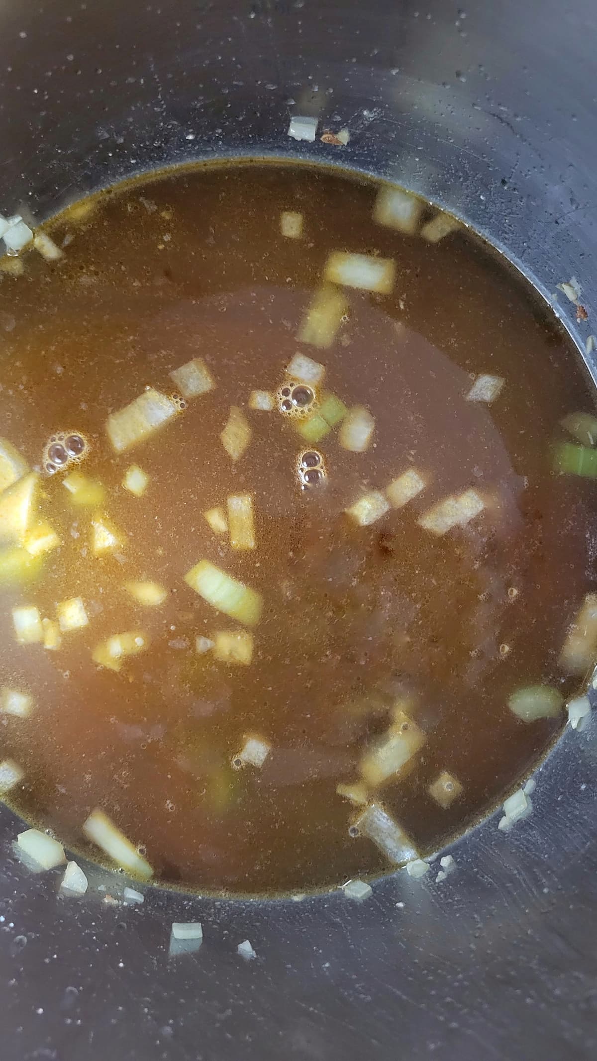 diced onions in broth in a pot