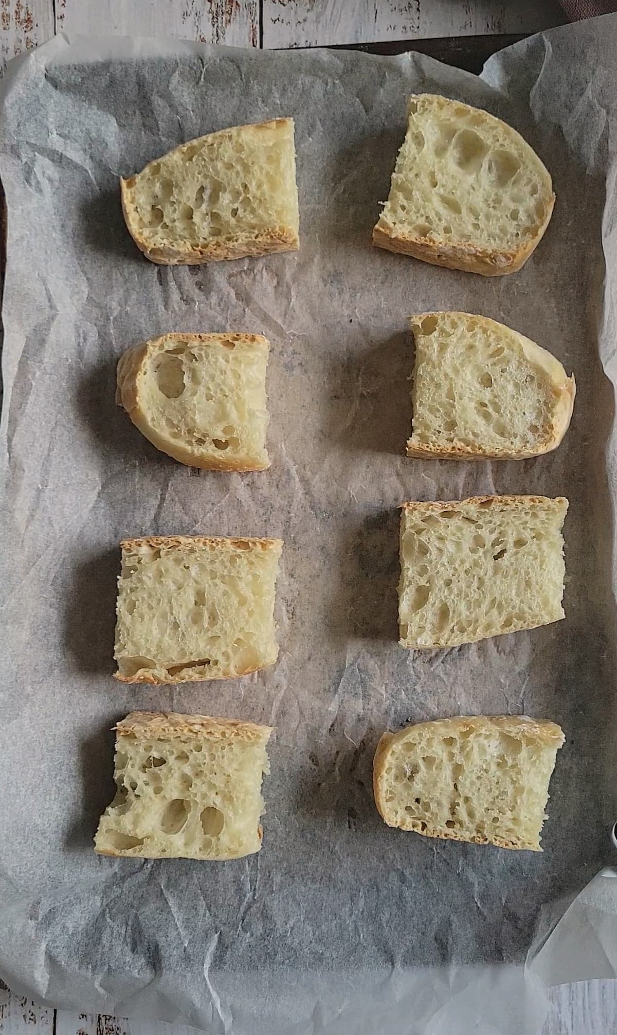 pieces of bread on a parchment lined baking sheet