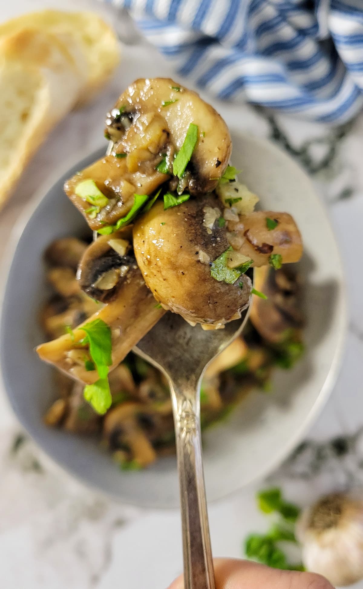 spoonful of mushrooms over a bowl with the rest