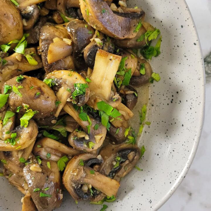 garlic butter mushrooms with parsley in a bowl