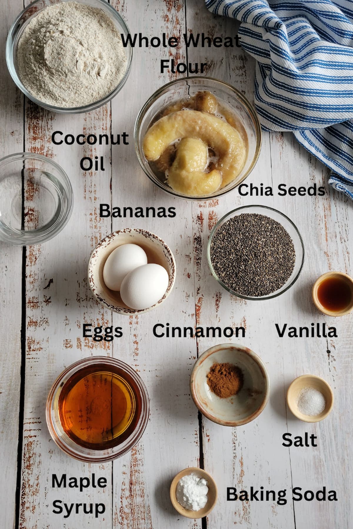 ingredients for recipe for banana bread healthy - bananas, whole wheat flour, vanilla, salt, chia seeds, maple syrup, cinnamon, baking soda, coconut oil, eggs