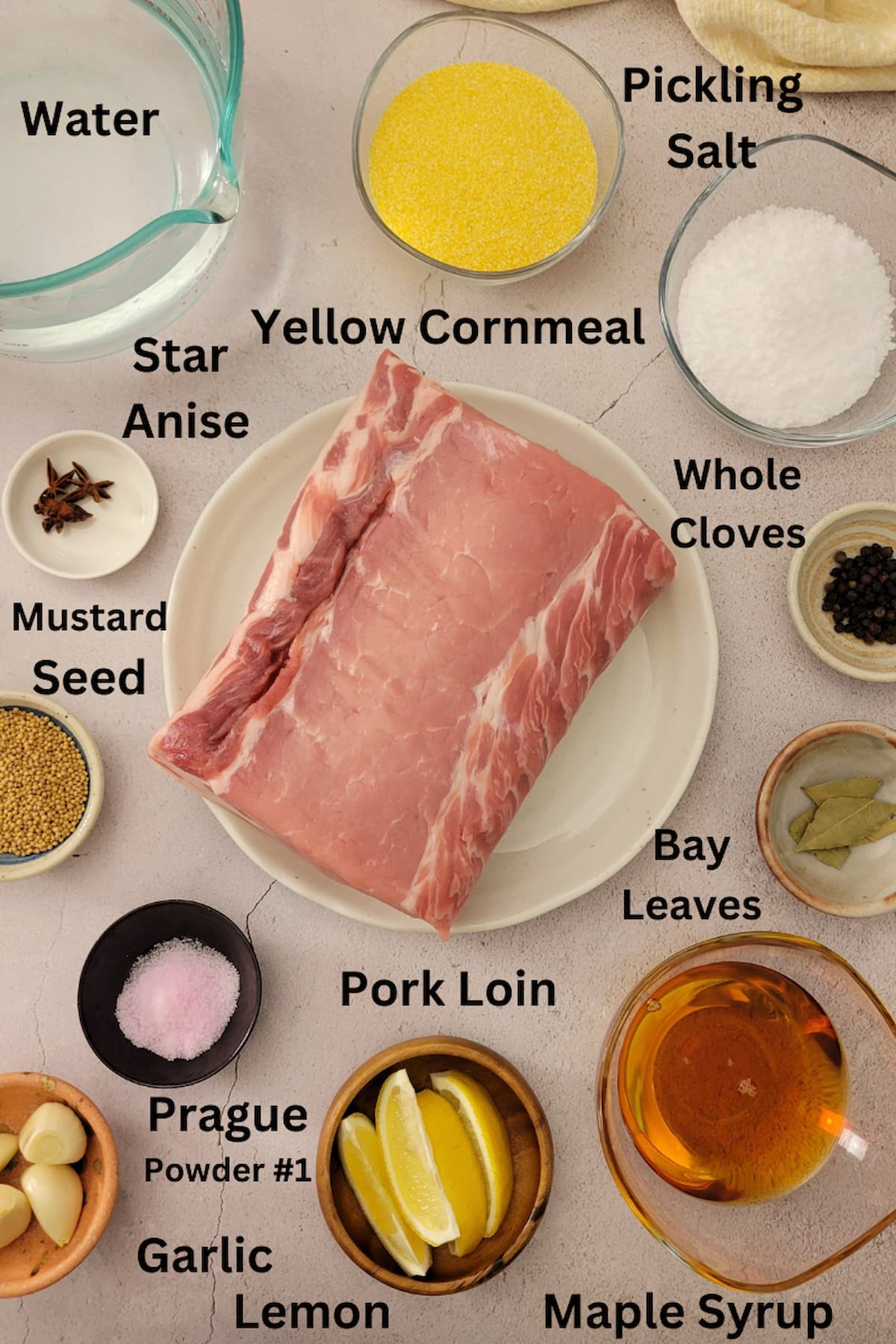 ingredients for peameal bacon - pork loin, yellow cornmeal, water, salt, star anise, mustard seed, prague powder#1, galic, lemon, maple syrup, bay leaves, whole cloves