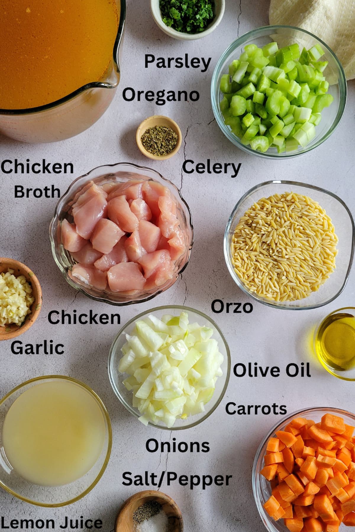 ingredients for greek chicken soup with lemon and orzo - chicken, lemon juice, orzo, onions, celery, garlic, carrots, parsley, salt/pepper, olive oil, chicken broth, oregano