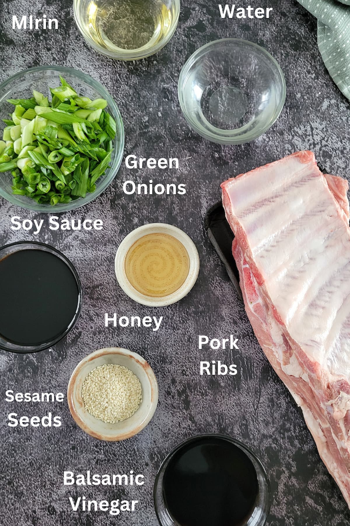 ingredients for ribs asian - pork ribs, green onions, sesame seeds, balsamic vinegar, water, honey, mirin, soy sauce
