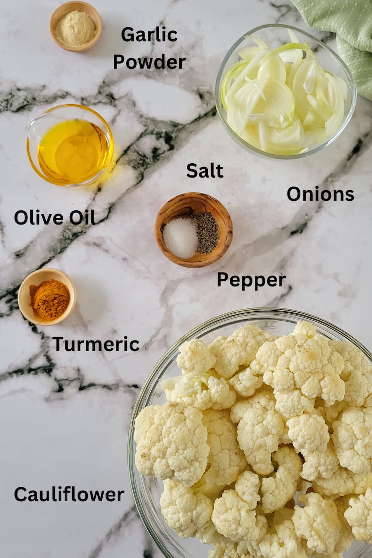 ingredient list for baked cauliflower - cauliflower, olive oil, salt, pepper, onions, turmeric, garlic powder