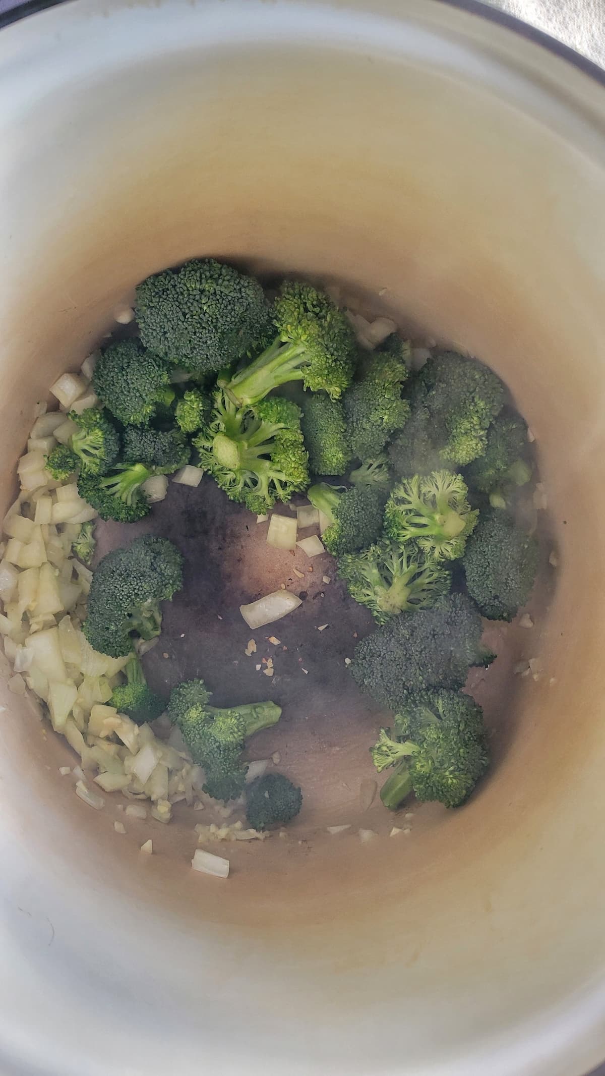 broccoli florets and diced onions in a pot