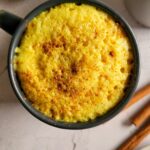 turmeric latte in a mug topped with cinnamon