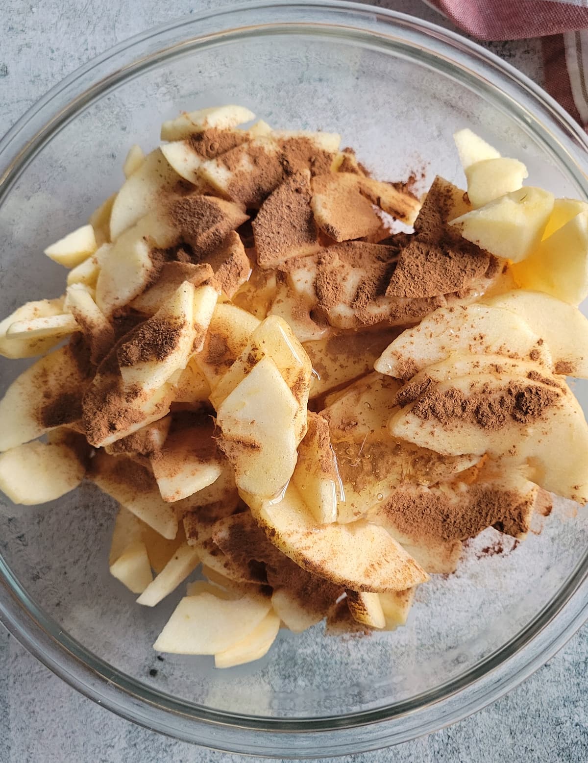 sliced apples in a bowl with cinnamon