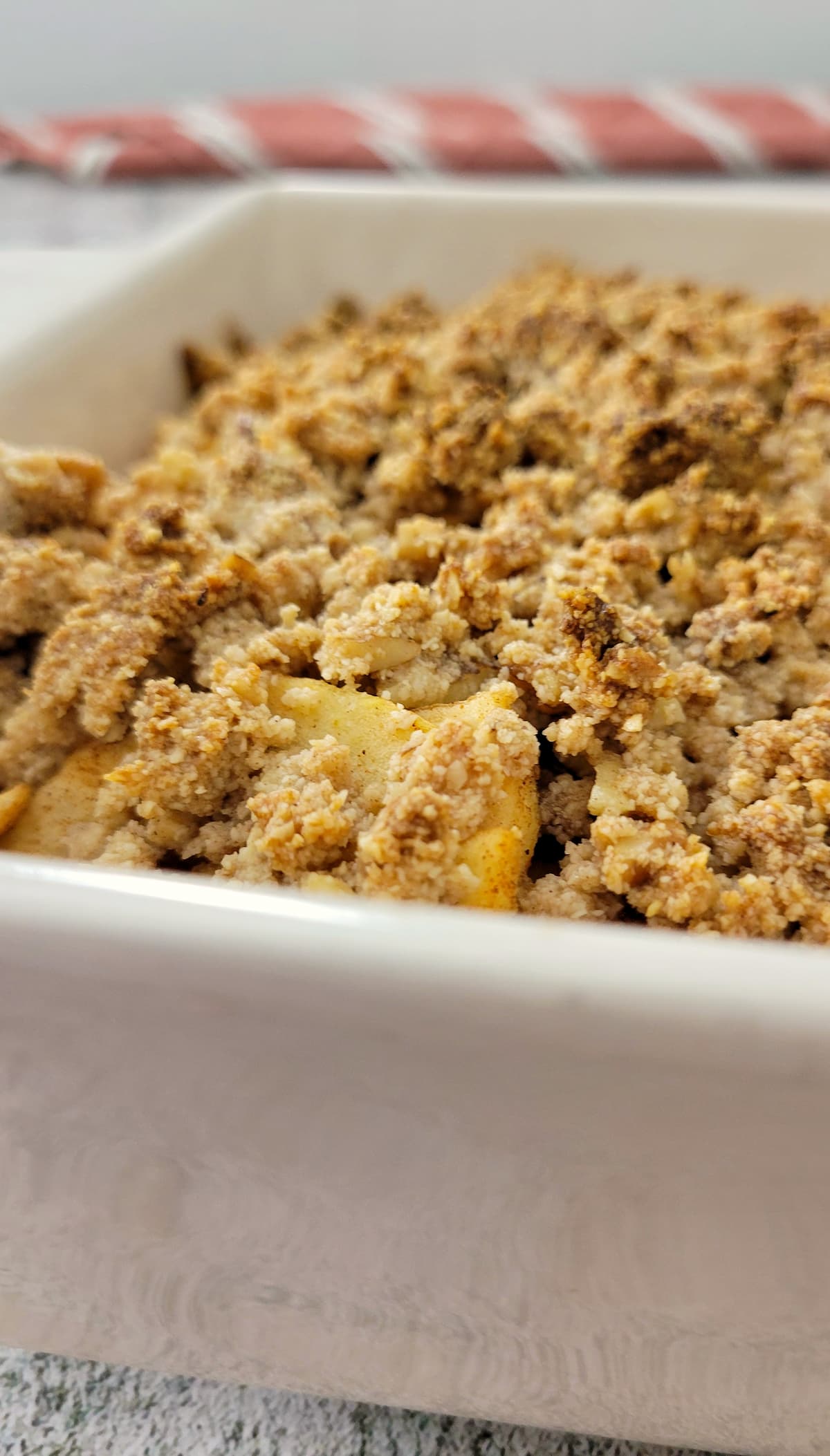 side view of golden apple crisp in a baking dish