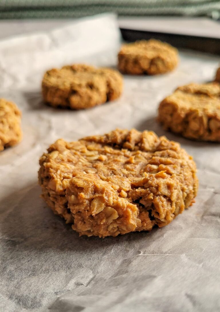 peanut butter oatmeal cookies on a parchment lined baking sheet