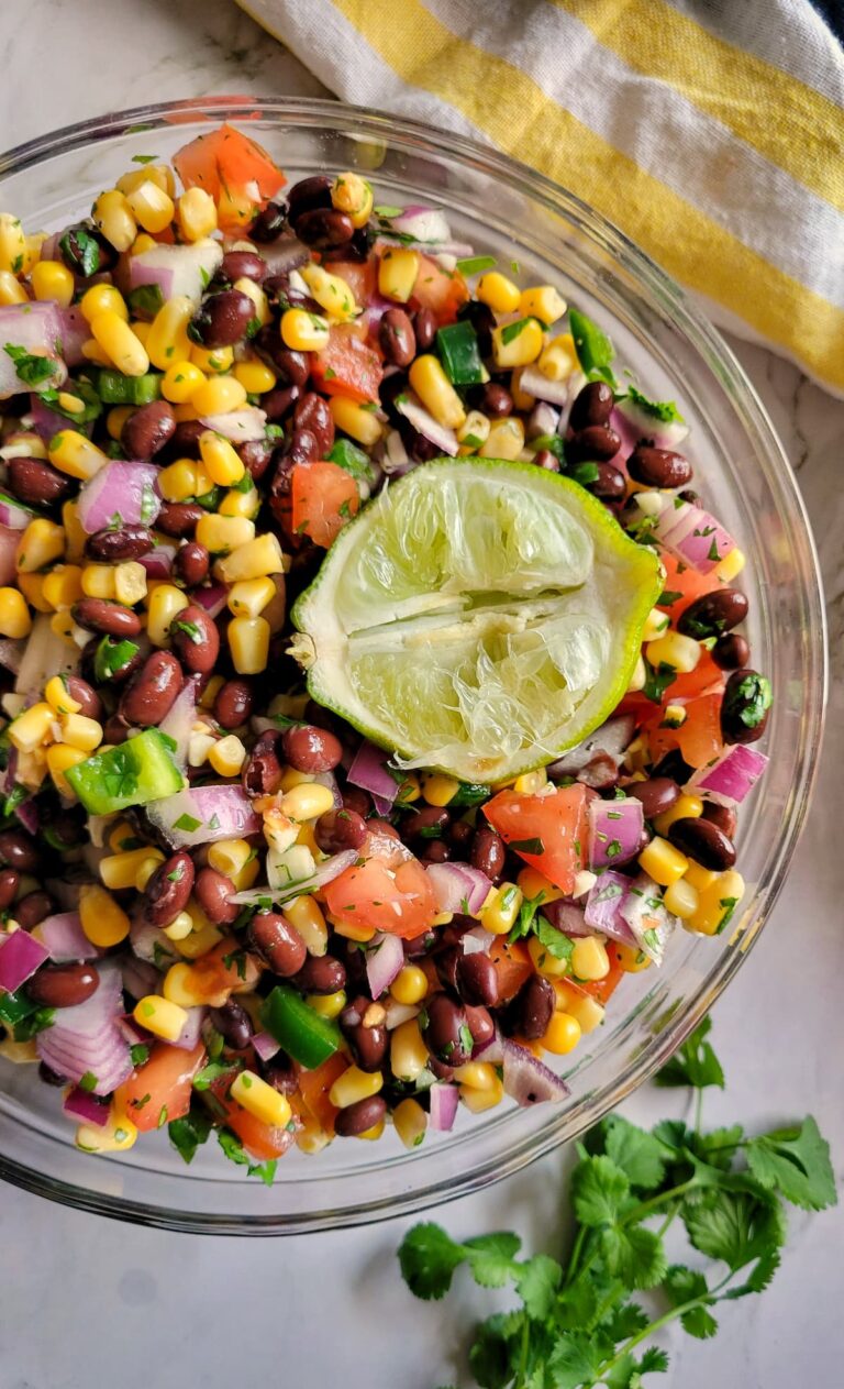 black bean and corn salsa in a bowl with a squeezed lime
