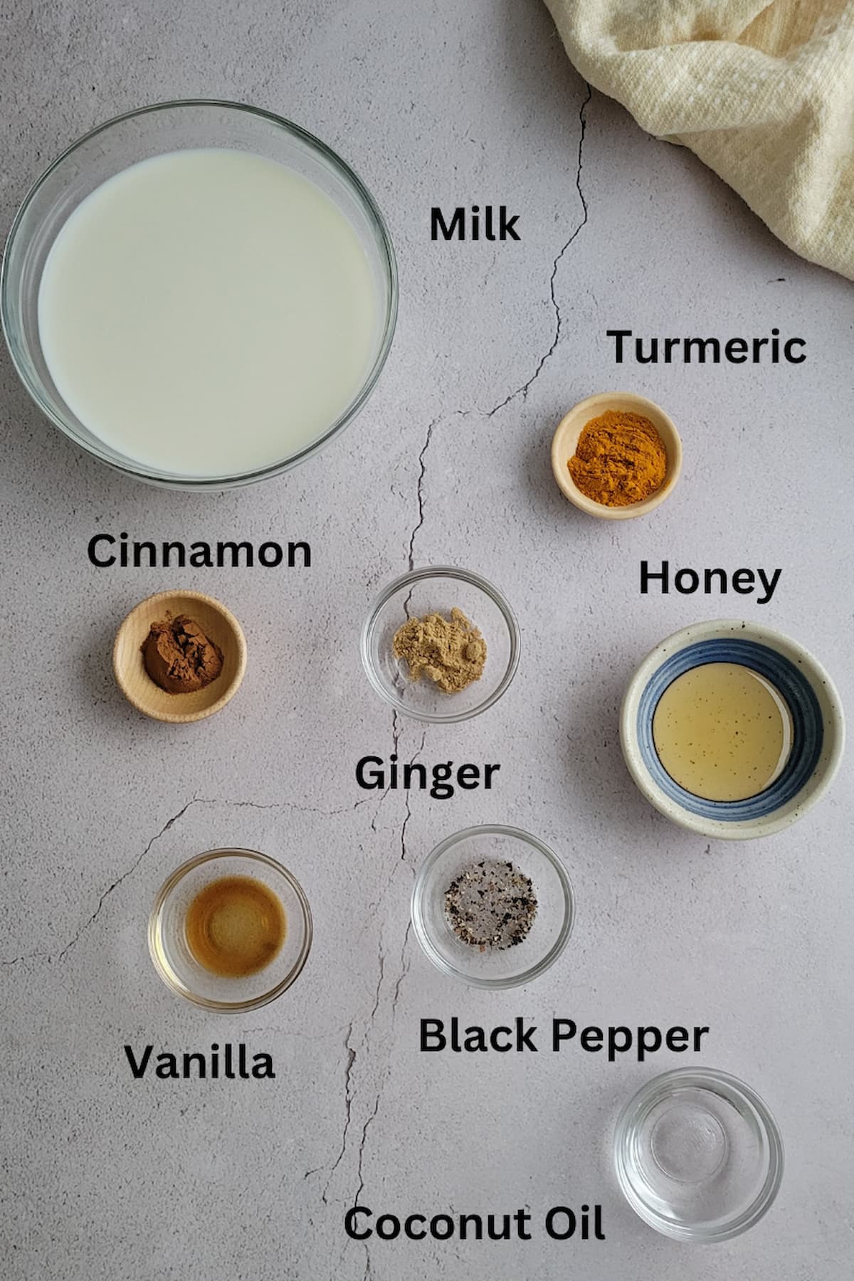ingredients for recipe turmeric latte - turmeric, milk, ginger, coconut oil, honey, black pepper, cinnamon, vanilla, ginger