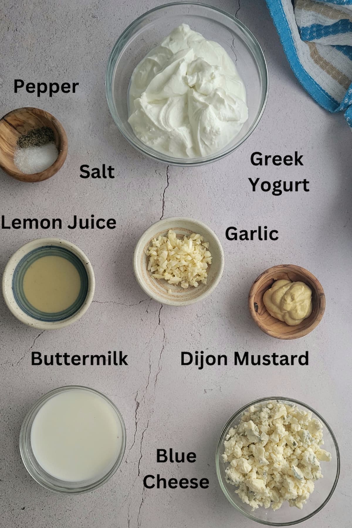 ingredients to make greek yogurt blue cheese salad dressing - blue cheese, greek yogurt, lemon juice, garlic, dijon mustard, buttermilk, salt and pepper