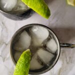 two irish mule cocktails with ice and lime wedge