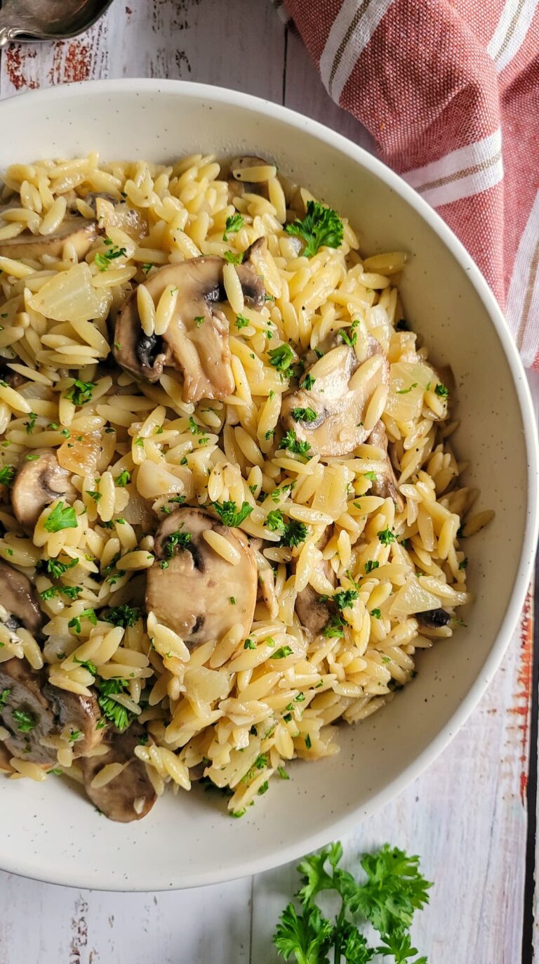 orzo with mushrooms and fresh chopped parsley in a bowl
