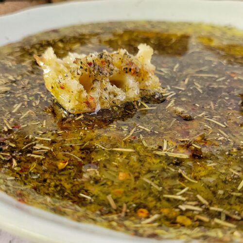 piece of bread in a plate with olive oil and spices