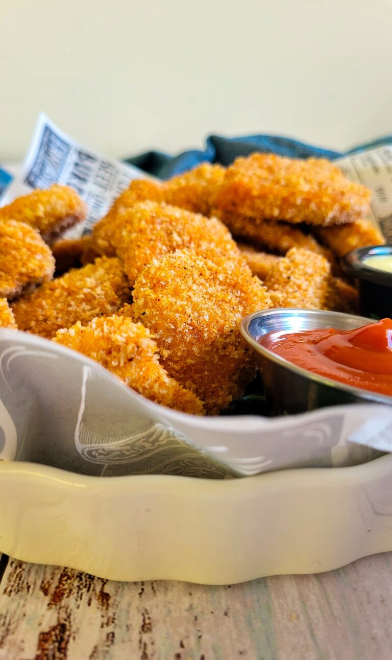 chicken nuggets in a lined dish with ketchup on the side