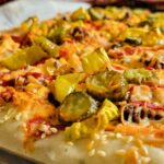 pizza with pickles, sesame seeds, pepperoncini